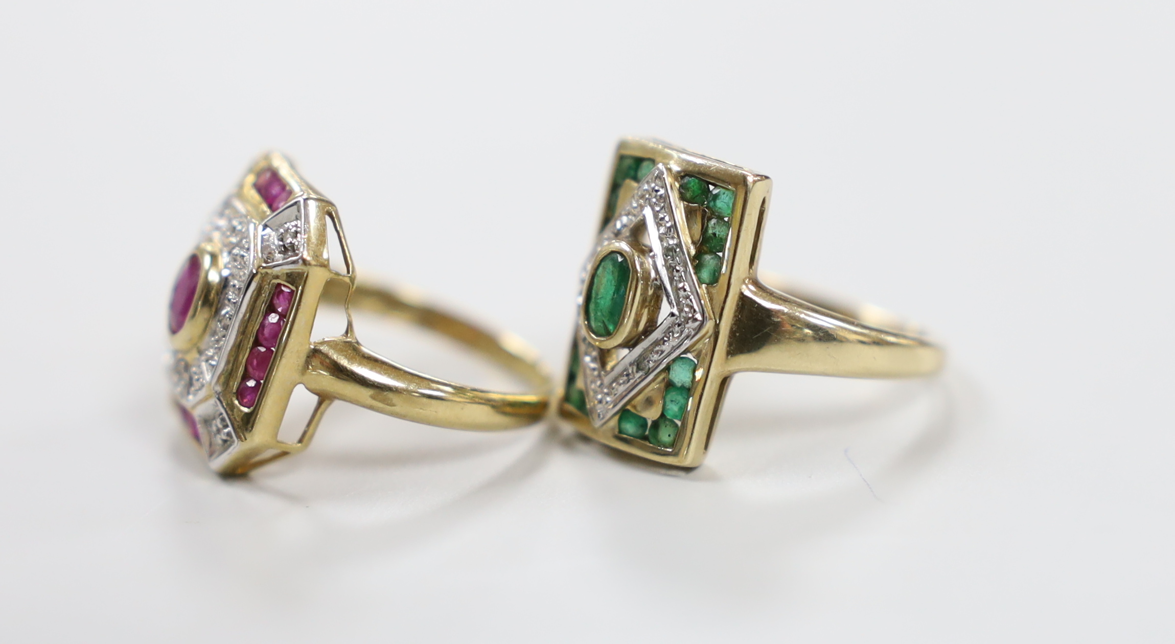 A modern 9ct gold, emerald and diamond chip cluster set table ring, size N and a similar ruby and diamond chip cluster set ring, gross weight 7.7 grams.